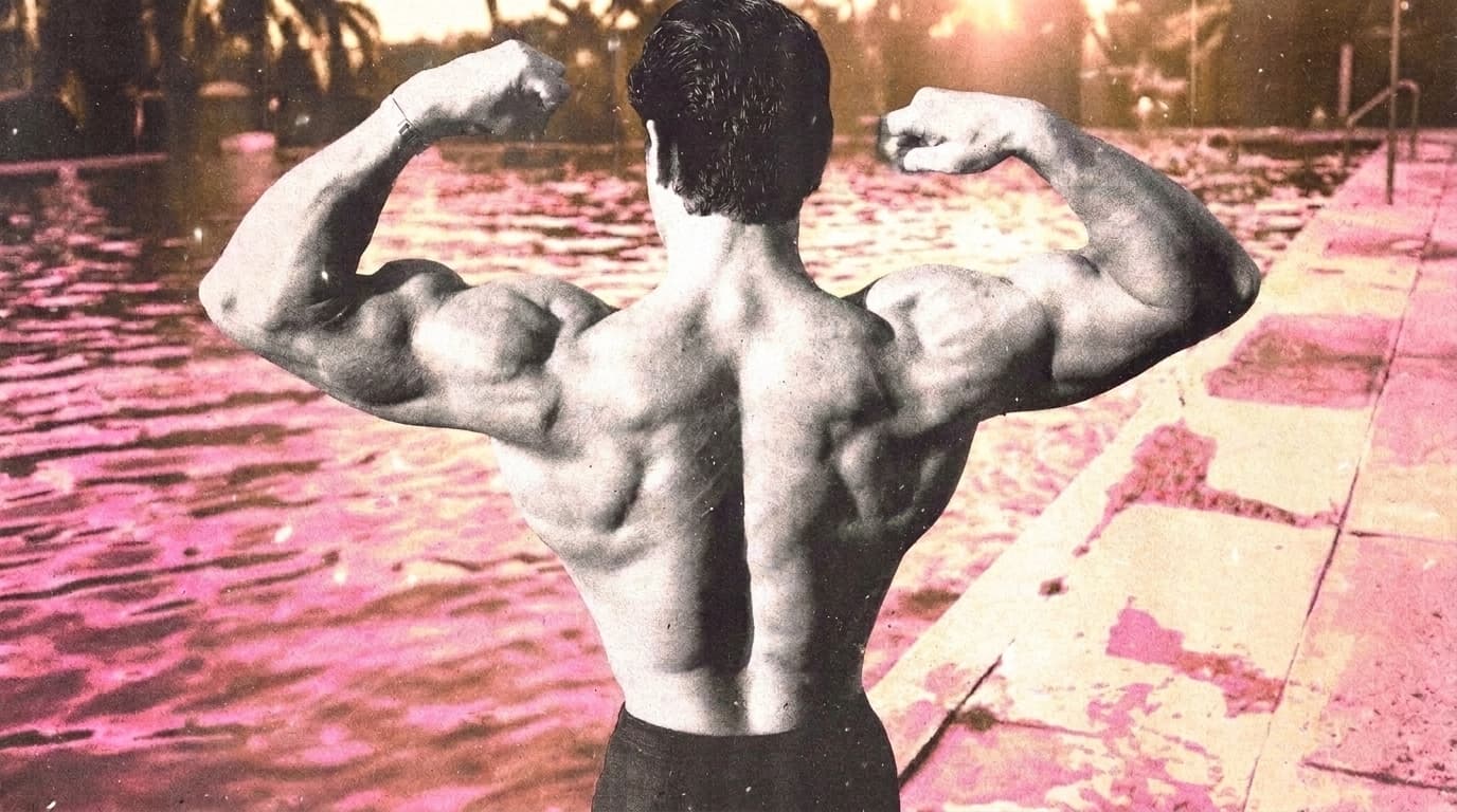 A bodybuilder runner in vintage black and white hits a rear double-biceps pose beside a pink-tinted swimming pool at sunset